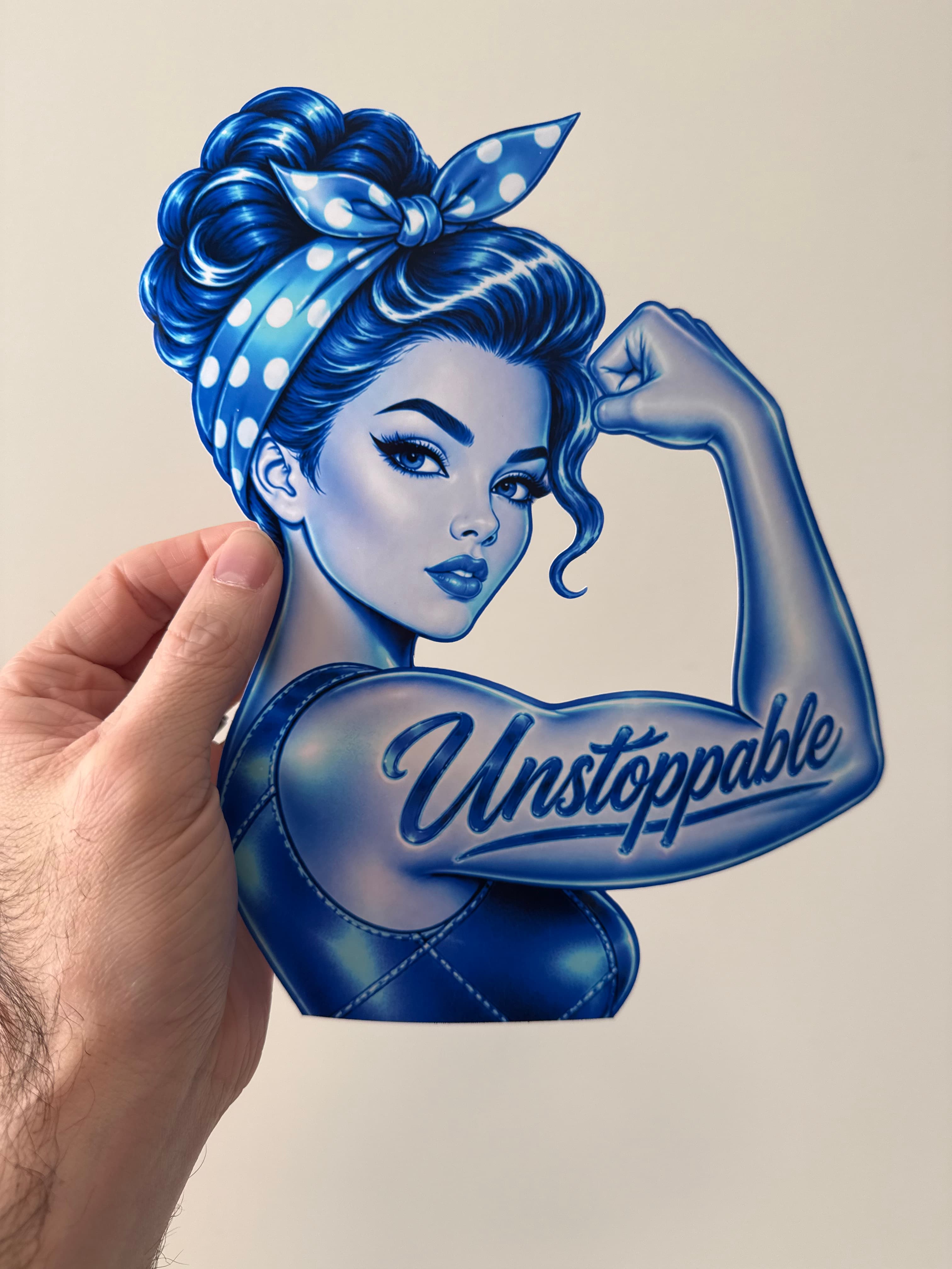 A blue Unstoppable illustrated cutout held in hand